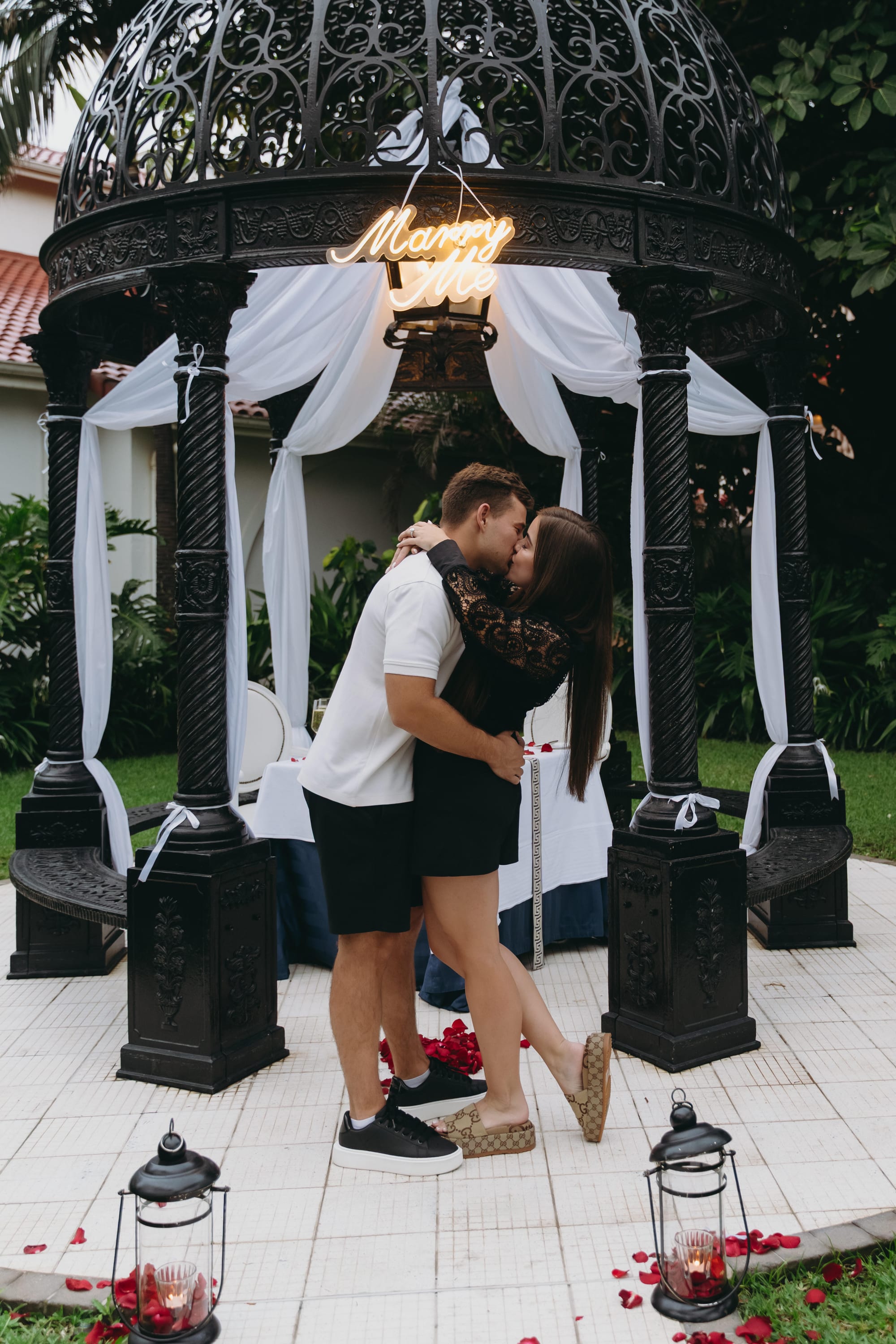 Savannah and Justin kissing in the garden gazebo