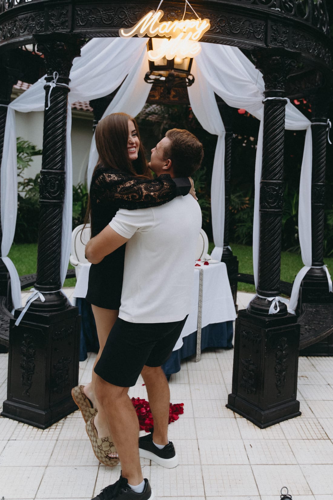 Savannah and Justin embracing under the gazebo